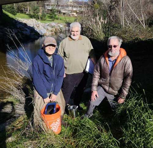 Three SARSAS volunteers beside Auburn Ravine with water-testing equipment